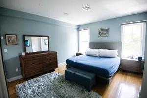 Inviting bedroom suite with cozy bedding and warm lighting.