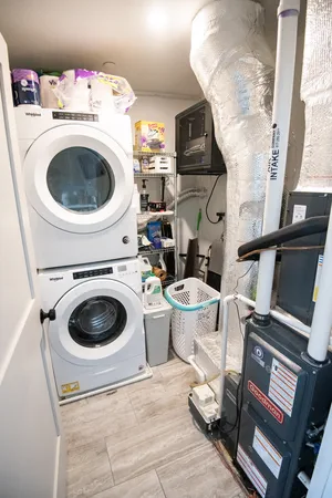 Modern laundry room with washer, dryer, and organized storage.