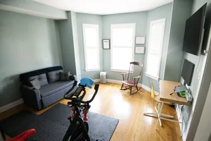 Dual-purpose room featuring office setup and fitness equipment.